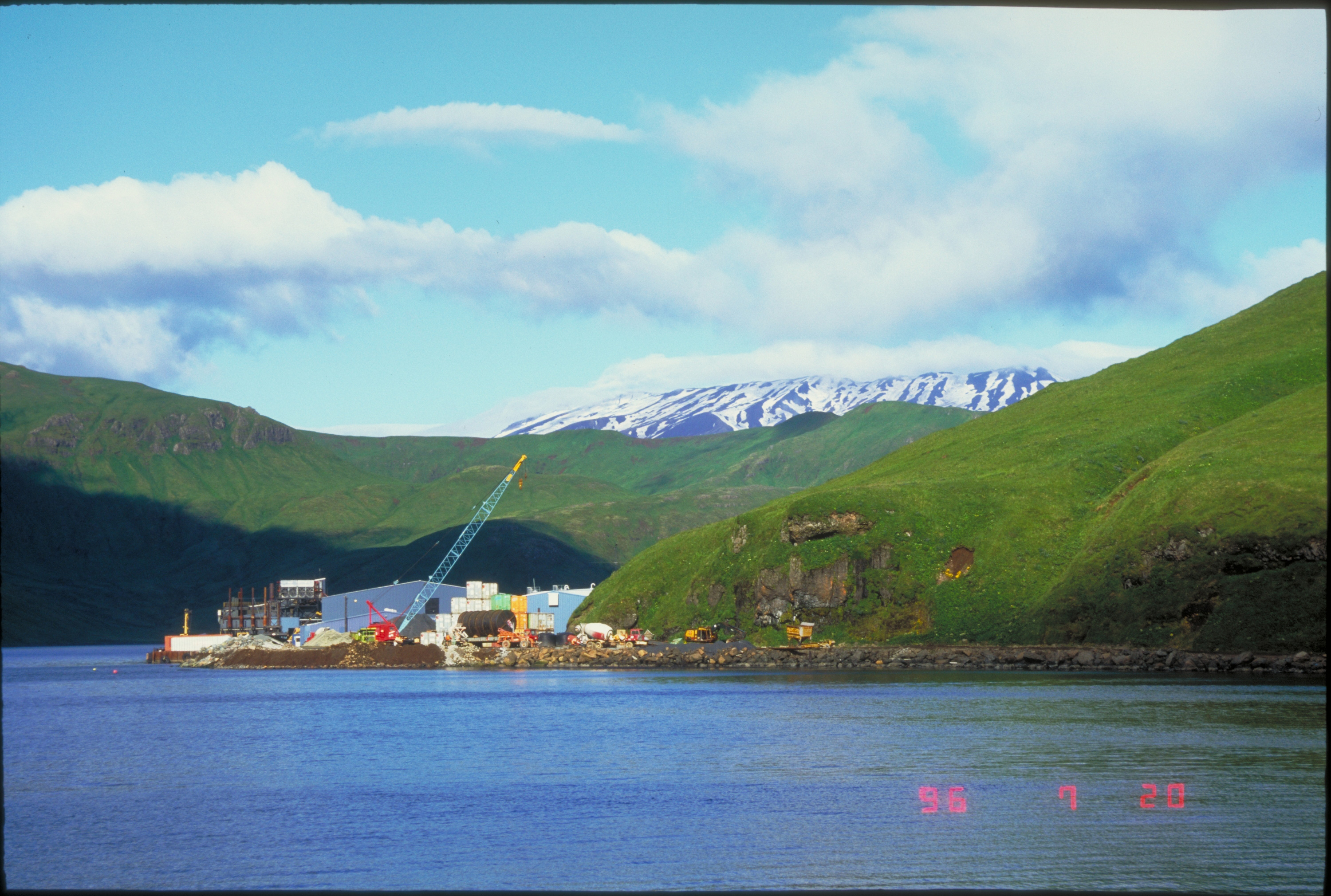 Trident seafood processing plant at Akutan Harbor. Akutan Volcano is