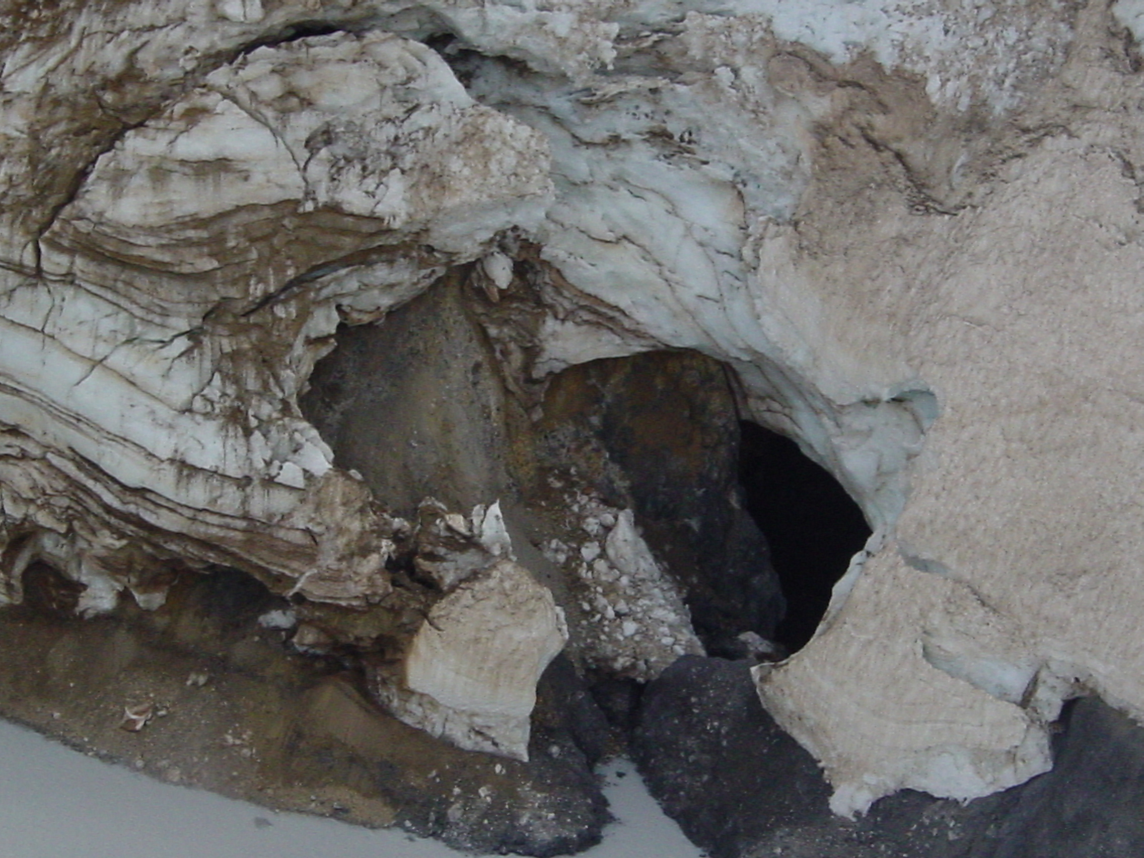 Close-up of the outlet cave for the summit crater lake at Chiginagak ...