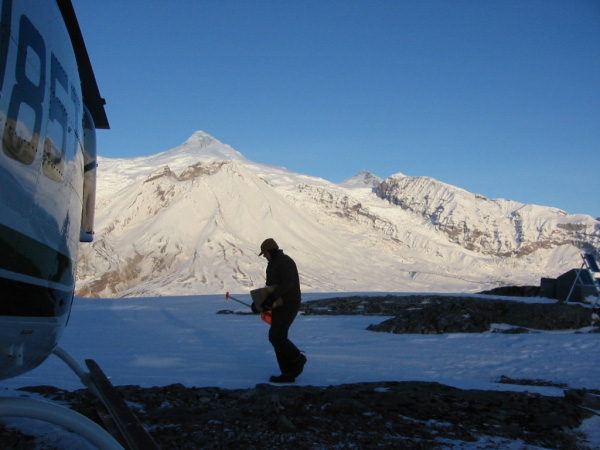 Cyrus Read loading the helicopter at station CKT, with Mt. Spurr and Crater Peak in the background.