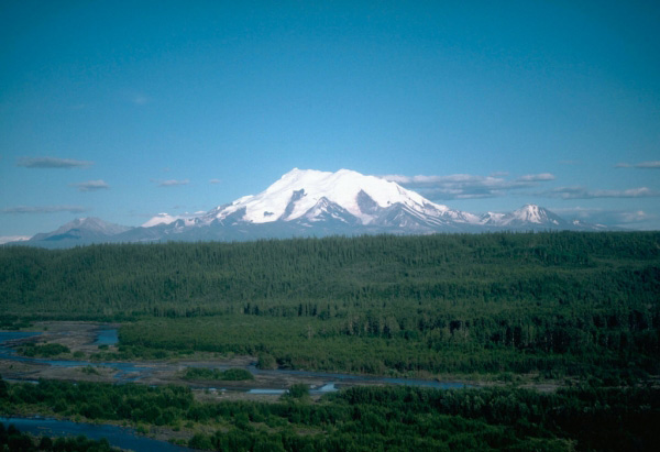 Mount Drum, the westernmost volcano in the Wrangell 
volcanic field. Mount Drum is 3,661 m (12,010 ft) high and 
was active between approximately 700,000 and 240,000 years 
ago. View is to the southeast. Photograph by D. Richter, 
U.S. Geological Survey, 1989.