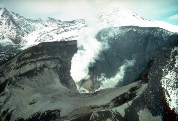 Following a brief, violent eruption on June 27, 1992, the interior of the Crater Peak vent steams vigorously. Newly deposited pyroclastic debris covers the interior of the crater and the preeruption crater lake shown in photograph 14 is completely gone. View is to the north. Photograph by C. Nye, Alaska Division of Geological and Geophysical Surveys, June 28, 1992.