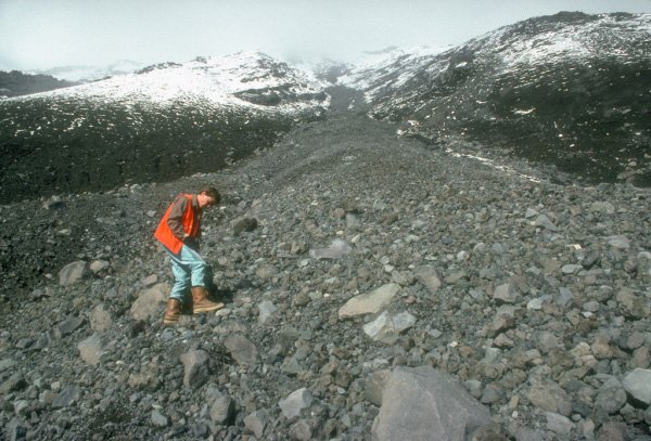 Alaska Volcano Observatory scientist sampling the 
pyroclastic flow deposit from the August 18, 1992, eruption 
of Crater Peak, a satellite vent of Mount Spurr volcano. 
View is to the northwest looking up the southeast flank of 
Crater Peak. Photograph by R. McGimsey, U.S. Geological 
Survey, September 9, 1992.