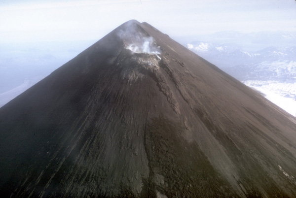 Steam and volcanic gas rising from the summit crater of 2,519-m (8,264 ft)-high Pavlof Volcano on the Alaska Peninsula. Pavlof is one of the most active of Alaska's volcanoes with nearly 40 historical eruptions.  Photograph by T. Miller, U.S. Geological Survey, November, 1973.