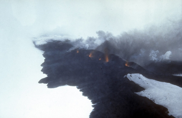 Incandescent lava fountaining from a fissure eruption near Pyre Peak on 1,054-m (3,458 ft)-high Seguam Island in the central Aleutian Islands. U.S. Coast Guard photograph, March 8, 1977.