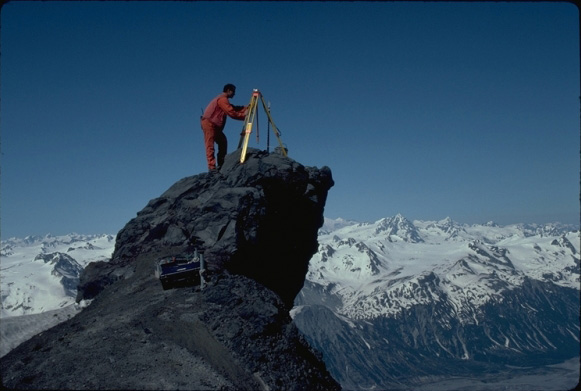 Geologist Jack Kleinman sets up a tripod at the 6200' level on the north flank of Redoubt Volcano, Alaska.  A Global Positioning System antenna was placed on the tripod as part of a volcano-wide survey to look for deformation of the edifice.