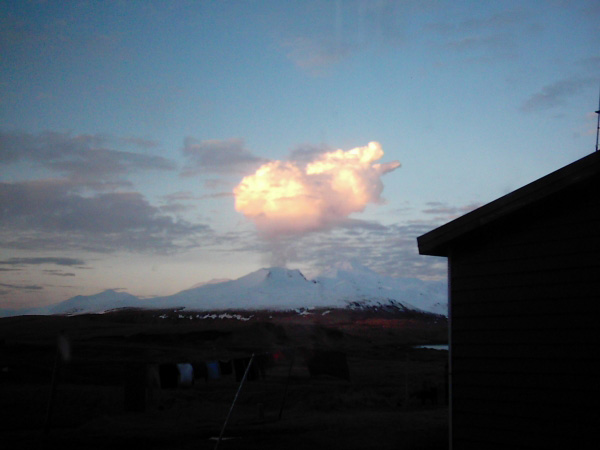 Steam plume developing over Korovin Volcano at about 7 p.m. on February 23, 2005, and drifting eastward. Ash was observed falling locally out of the base of the cloud. View is from Atka Village. Photographs courtesy of Louis and Kathleen Nevzoroff.