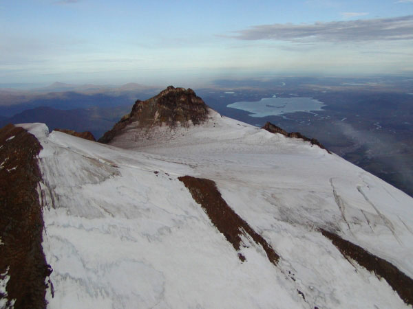 Summit of Chiginagak Volcano with Mother Goose Lake to the west.