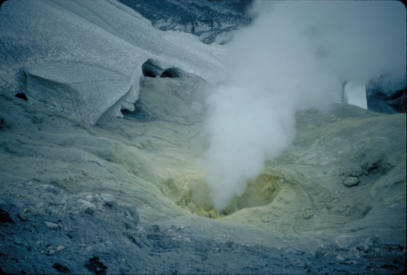 Fumarole vent at the summit of Makushin Volcano.  Bright yellow sulfur deposits surround the vent.