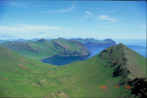 View east of Cascade Bight, Akutan Island, from peak 1701T.  Pre-Akutan volcanic strata dips to the south.