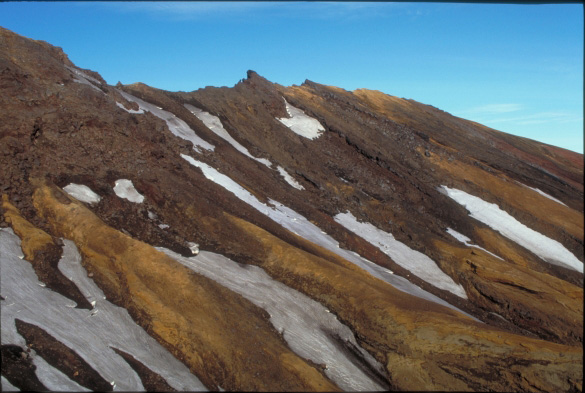 The spatter and pyroclastic flow covered northeast rim of Akutan Volcano caldera.