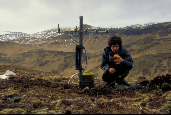 John Power testing the components of temporary seismic station AK4, located on the south side of Akutan Harbor.