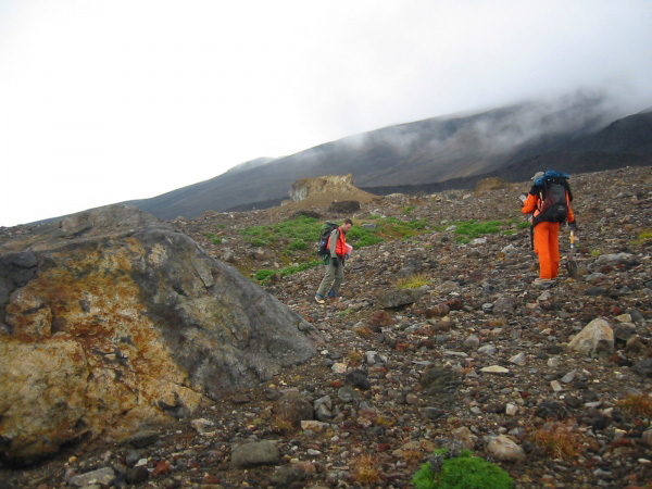 Brandon Browne and Game McGImsey crossing debris flow emplaced at the end of the 1929 eruption, south flank of Gareloi. Debris flow contains many large blocks of hydrothermall altered crater rock.  