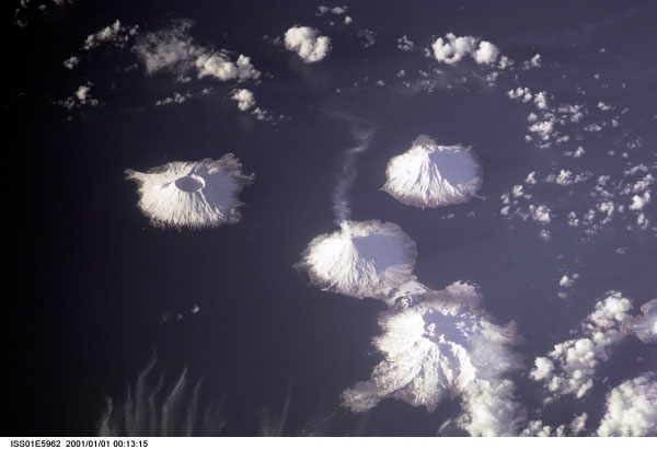 Image of Herbert (left-most volcano), Carlisle (upper volcano) and Mount Cleveland (stratovolcano with small steam plume).

Mission: ISS001 Roll: E Frame: 5962 Mission ID on the Film or image: ISS01
Country or Geographic Name: USA-ALASKA
Features: ISLANDS OF FOUR MTS.,SMK
Center Point Latitude: 53.0 Center Point Longitude: -170.0