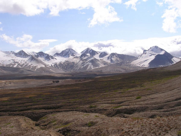 View of the northwestern side of Katmai Caldera, from the Valley of Ten Thousand Smokes, Katmai National Park and Preserve. The Knife Creek Glaciers extend from the crater rim to the right of center in the photo.