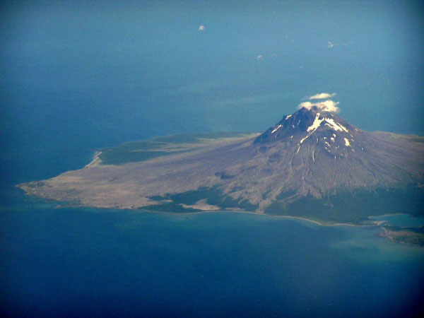 A closer view from a plane of the northern part of Mt. St. Augustine located in the Cook Inlet of Alaska. The view is to the east-southeast from the plane. In the photo the large debris flow fan deposit on the northern flank of the volcano is visible along with some lava flows on the upper flanks of the edifice.