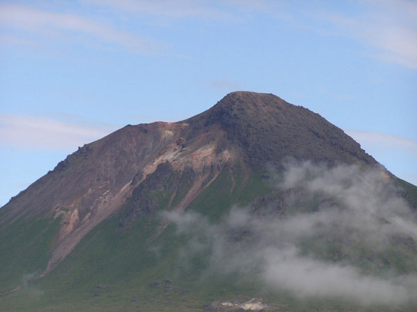 The southern flank of Kagamil Volcano. A younger lava flow (based on the little amount of vegetation on the surface of the flow) is observed on the right side (eastern side) of the summit.