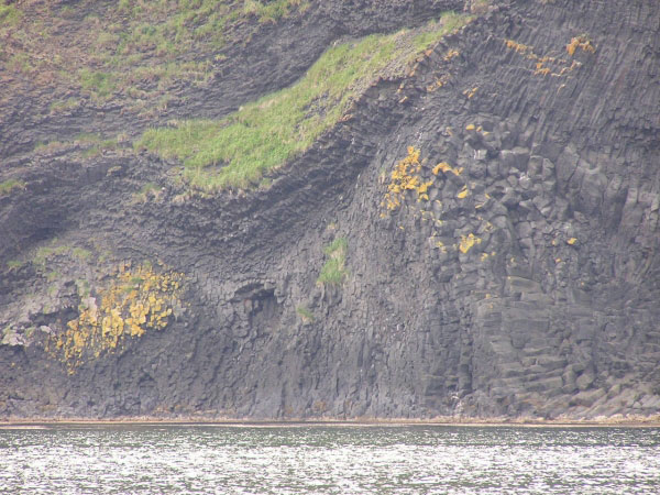 Photo of columnar jointing within large coastal outcrops of lava flows from Makushin Volcano on Unalaska Island, AK.
