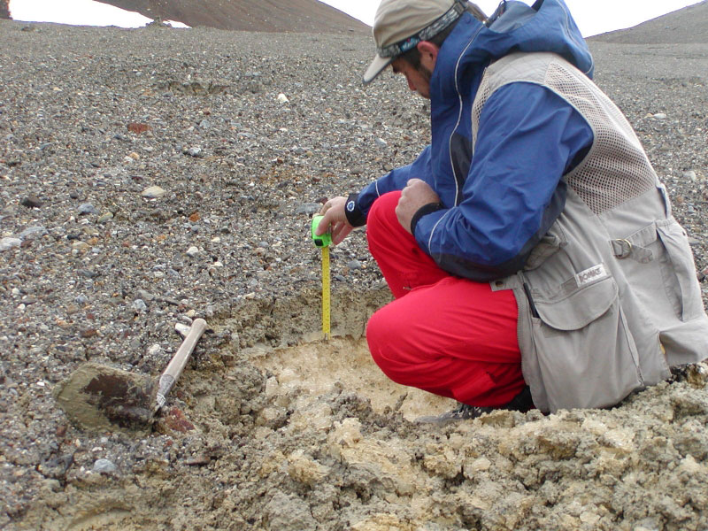 Willie Scott, USGS, measures the thickness of a flow lobes of a dark gray, clay-rich lahar that resulted from the draining of the summit caldera lake sometime in early summer 2005. 