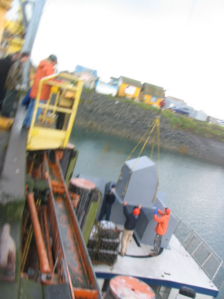 Loading the huts onto the Maritime Maid.  These gray huts are used to protect the communications equipment and batteries used to get the signal back to AVO