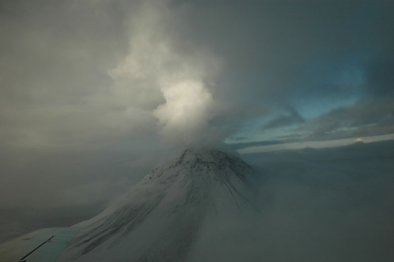 Observation flight after early morning steam eruptive activity on 1/11/06. Snow and rock avalanche on southwest flank; lahars visible on eastern and northern flanks.
