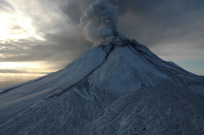 Augustine emitting steam and ash. Lahars (volcanic mud flows) on northern flank of volcano originating from the summit area on 1/11/06 and 1/12/06. Photo courtesy of Michelle Coombs, AVO/USGS. 