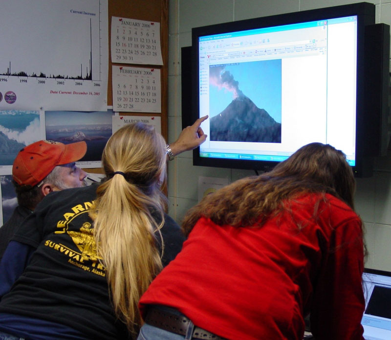 AVO staff monitoring volcanic activity at Augustine Volcano.  An on-island web camera shows Augustine blanketed in ash which was covered in snow earlier today (1/13/06). 
