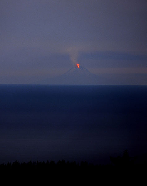 This 10-minute-exposure image was taken from Homer by photographer Dennis Anderson in the early morning hours of January 17th 2006.  The glow from the summit of Augustine volcano is clearly visible.