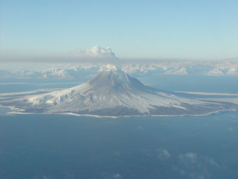 A continuous plume of gas rises from the summit of Augustine Volcano on January 24, 2006, creating a brown-gray haze southeast of the volcano.