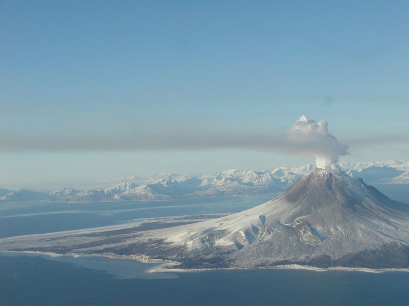 A continuous plume of gas rises from the summit of Augustine Volcano on January 24, 2006, creating a brown-gray haze southeast of the volcano.