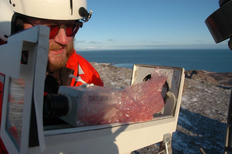 Dave Schneider filling openings in webcamera housing.