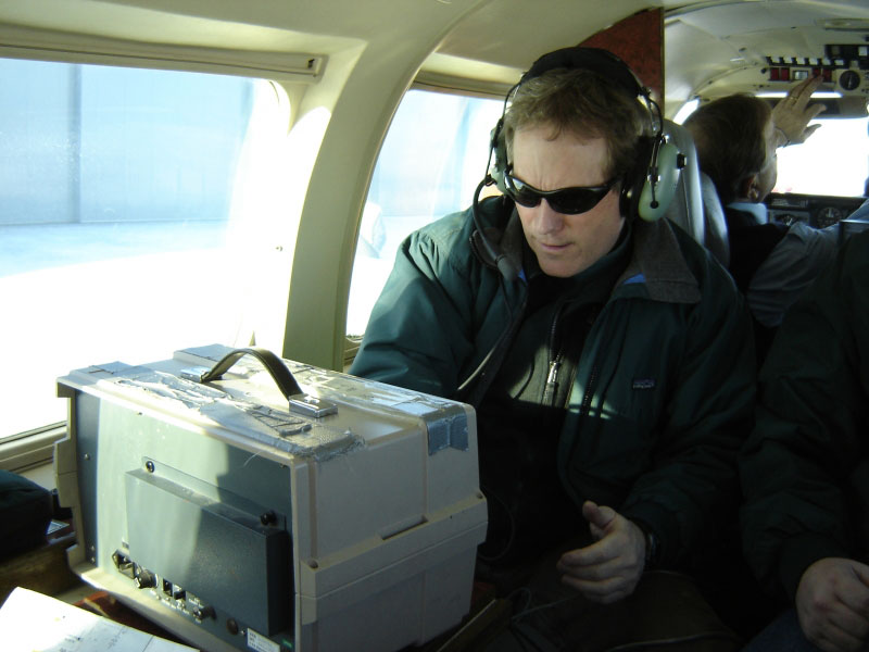Game McGimsey preparing the AVO COSPEC instrument for use during an overflight at Augustine Volcano, February 8, 2006.