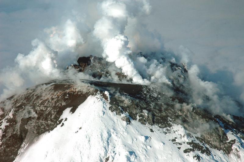 Summit of Augustine volcano showing new lava dome and deposits.  Note that the "moat", south of the dome, is now filled in with tephra and debris.  View from south-southeast.