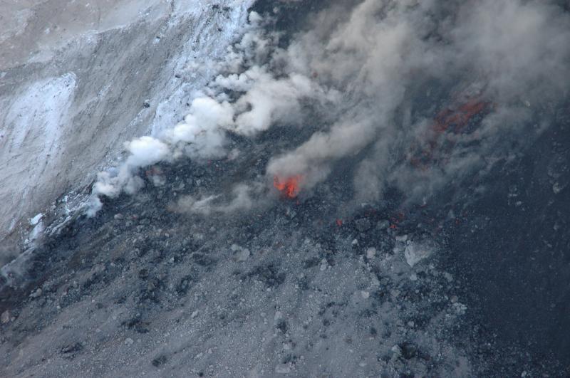 Incandescent blocks cascading off of the advancing flow front of the active lava flow on northeast flank.  Zoom-in on the central incandescent block [or look at the "Full Size" image], and you can see that as it disintegrates, the "block" is actually viscous molten lava.