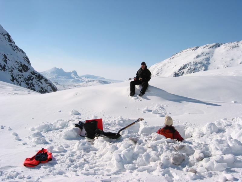 Kristi Wallace examining Augustine ash in a pit dug into snow near Ursus Cove 