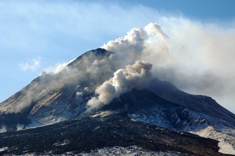 View , from the north, of Augustine's growing lava dome and flows. The front of the north lava flow is steaming vigorously.