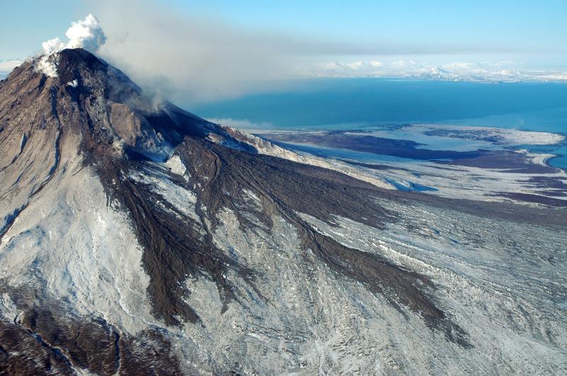 Augustine as seen from the northeast. The new, growing lava dome is visible at the summit, as is the northeast lava flow. Fans of debris have formed as the dome and flows shed blocks as they grow.