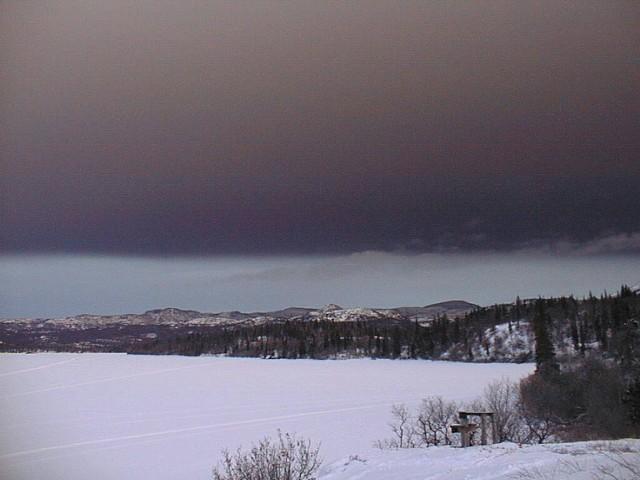 Dark ash cloud approaches Intricate Bay, SE Lake Iliamna, on Jan 17, 2006.
