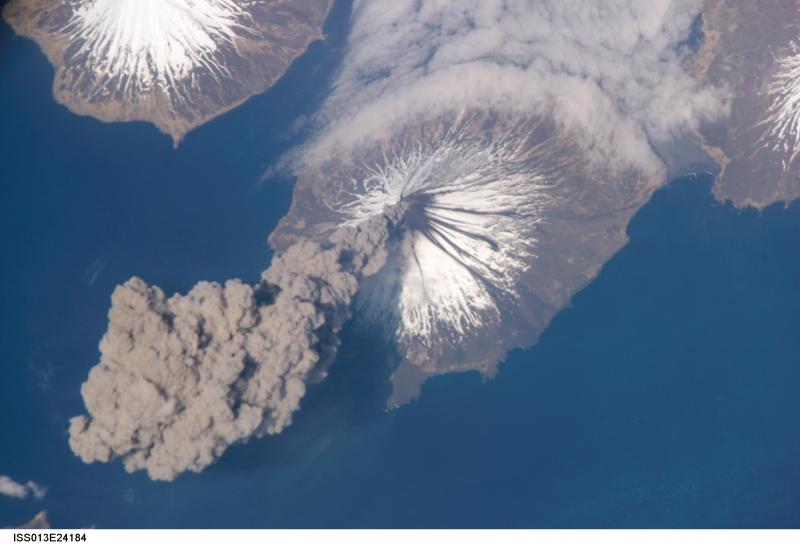 ISS013-E-24184 (23 May 2006) --- Eruption of Cleveland Volcano, Aleutian Islands, Alaska is featured in this image photographed by an Expedition 13 crewmember on the International Space Station. This most recent eruption was first reported to the Alaska Volcano Observatory by astronaut Jeffrey N. Williams, NASA space station science officer and flight engineer, at 3:00 p.m. Alaska Daylight Time (23:00 GMT). This image, acquired shortly after the beginning of the eruption, captures the ash plume moving west-southwest from the summit vent. The eruption was short-lived; the plume had completely detached from the volcano summit two hours later. Ash plumes from Cleveland Volcano have reached heights of 12 kilometers and can present a hazard to trans-Pacific jet flights. The fog bank visible at image top center is a common feature of the Aleutian volcanoes. Cleveland Volcano, situated on the western half of Chuginadak Island, is one of the most active of the volcanoes in the Aleutian Island chain extending west-southwest from the Alaska mainland. At a summit elevation of 1,730 meters, this stratovolcano is the highest in the Islands of the Four Mountains group. Carlisle Island to the north-northwest, another stratovolcano, is also part of this group. Magma that feeds eruptions of ash and lava flows from the volcano is generated by subduction of the northwestward-moving Pacific Plate beneath the North American Plate. As one tectonic plate subducts beneath another, melting of materials above and within the subducting plate produce magma that can eventually move to the surface and erupt through a vent (such as a volcano). Cleveland Volcano claimed the only known eruption-related fatality in the Aleutian Islands during 1944.

http://eol.jsc.nasa.gov/scripts/sseop/photo.pl?mission=ISS013&roll=E&frame=24184