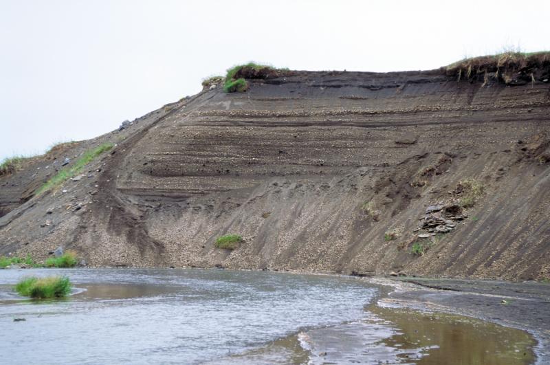 Cutbank along the lower Aniakchak River of fan flood deposits from catastrophic caldera outbreak flood. Location is near Mystery Creek.