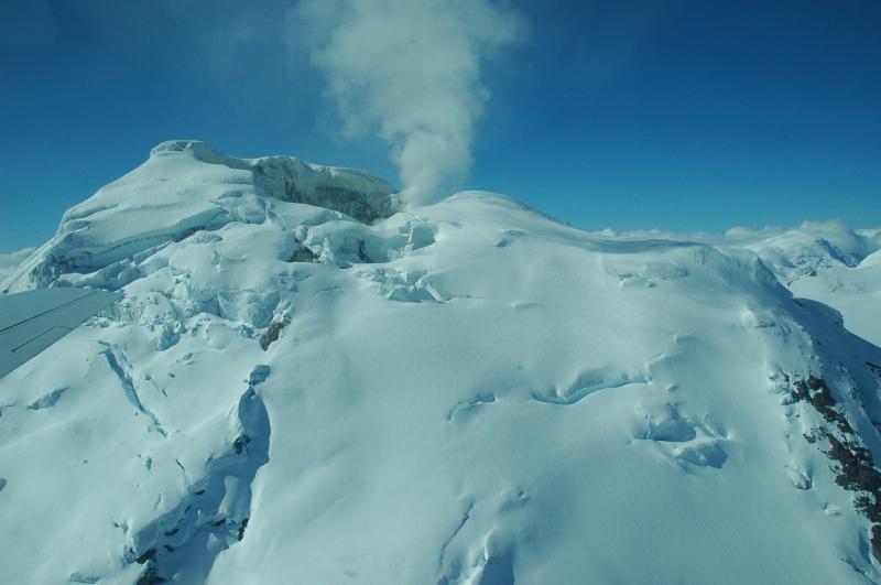 Spurr summit, gas/vapor plume, and SE flank with exposed areas of warm ground.