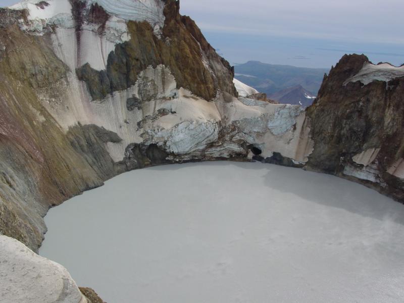 Summit crater lake at Chiginagak, formed in 2005 and catastrophically drained and flooded Indecision and Volcano creeks with acidic water.  Note outlet cave on far side of lake.