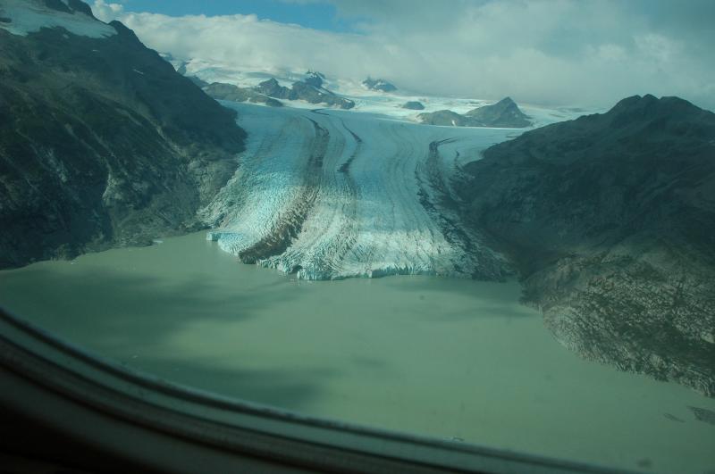 Snout of Fourpeaked Glacier with tunnel and sediment plume into unnamed lake. 