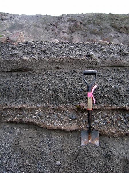 2006 lithic-rich pyroclastic-flow deposits sit atop pre-2006 deposits. Contact is hlafway up wooden shovel handle.