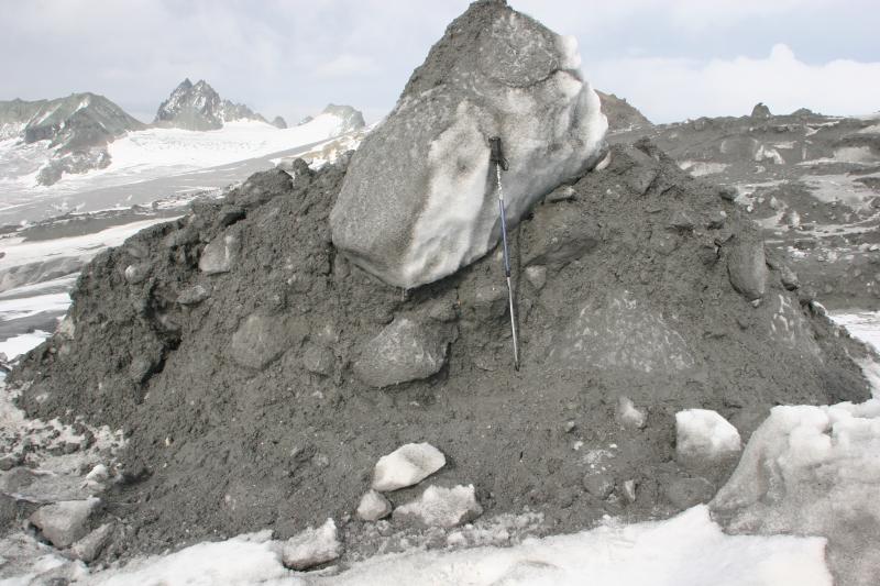 Photograph of flowage deposit of ice and debris on the NW flank of Fourpeaked volcano.  The debris/ice flow originated from a glacial outbreak flood caused by melting of summit glacial ice by volcanic processes on September 17, 2006. 