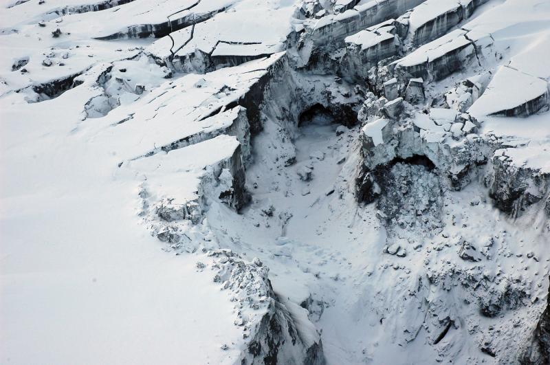 Photograph of sub glacial cavern, the site of a glacial outbreak flood caused by melting of summit glacial ice by volcanic processes on September 17, 2006. A debris flow and deeply incised canyons in the ice resulted from the outbreak flood.