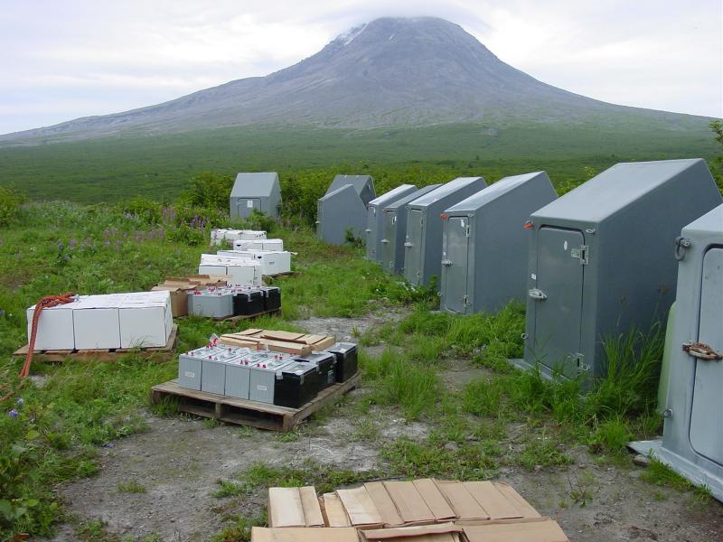 Augustine Field work, August, 2006. Staging area: storage huts for geophysical gear, pallets of batteries.. Augustine in background.