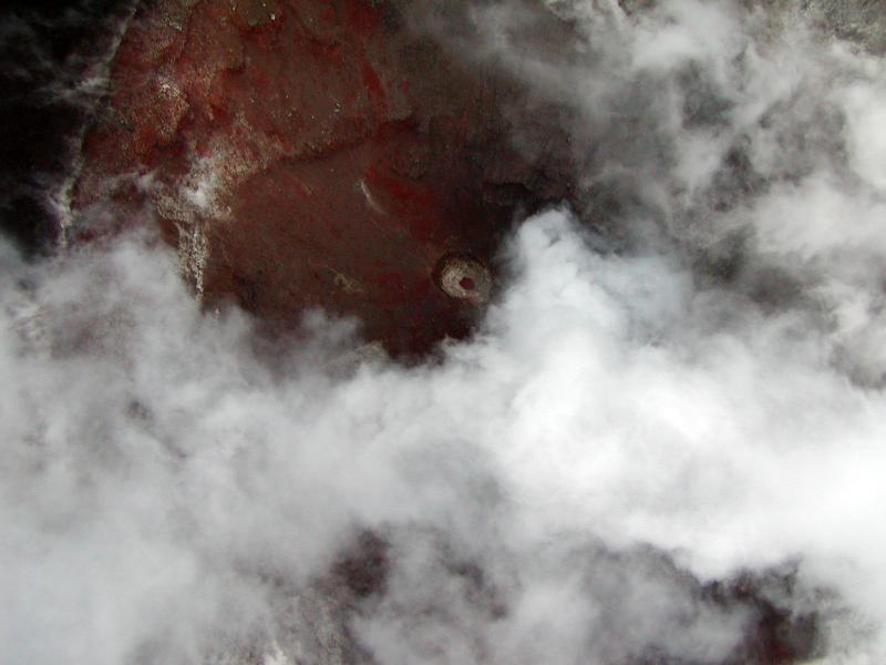 Incandescent rock can be seen through the small circular vent at Cone A, Okmok Volcano.