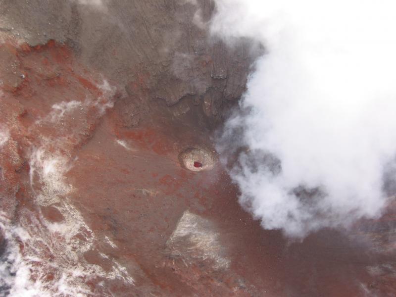 Incandescence visible inside a ~5-10-m diameter hole in the bottom of the summit crater at Cone A, Okmok Caldera.  