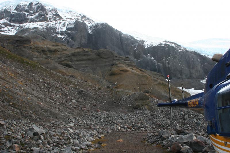 Fourpeaked area field work, 14-15 October, 2006. Pre-Holocene pyroclastic flow deposits (stratified deposits) underlying lavas, WNW of Fourpeaked. Jet Ranger helicopter in foreground.