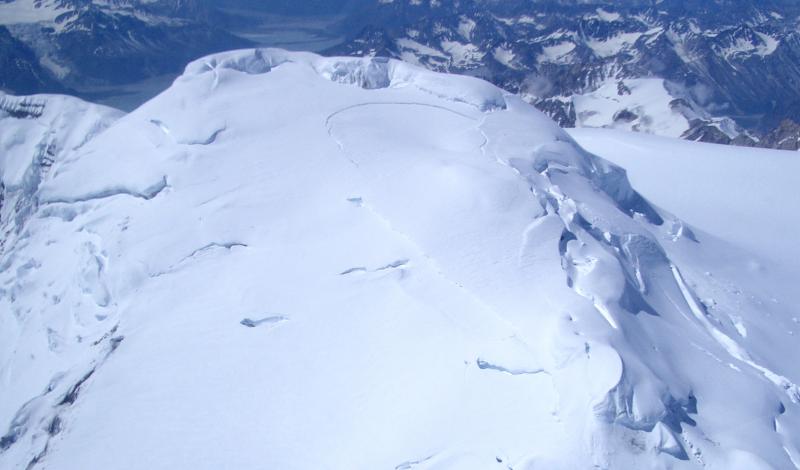 Earliest image of the initial development of ice collapse pit at the summit of Mount Spurr.  Note the crescentric crevassing and depressed area in the snow/ice.